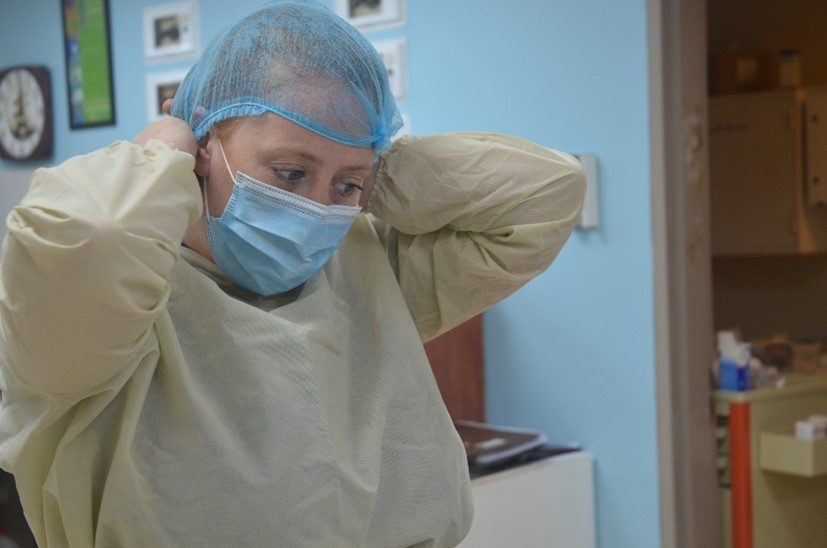 UK-Med Nurse Katy Drillsma-Millgrom puts on PPE in preparation for clinical coaching.