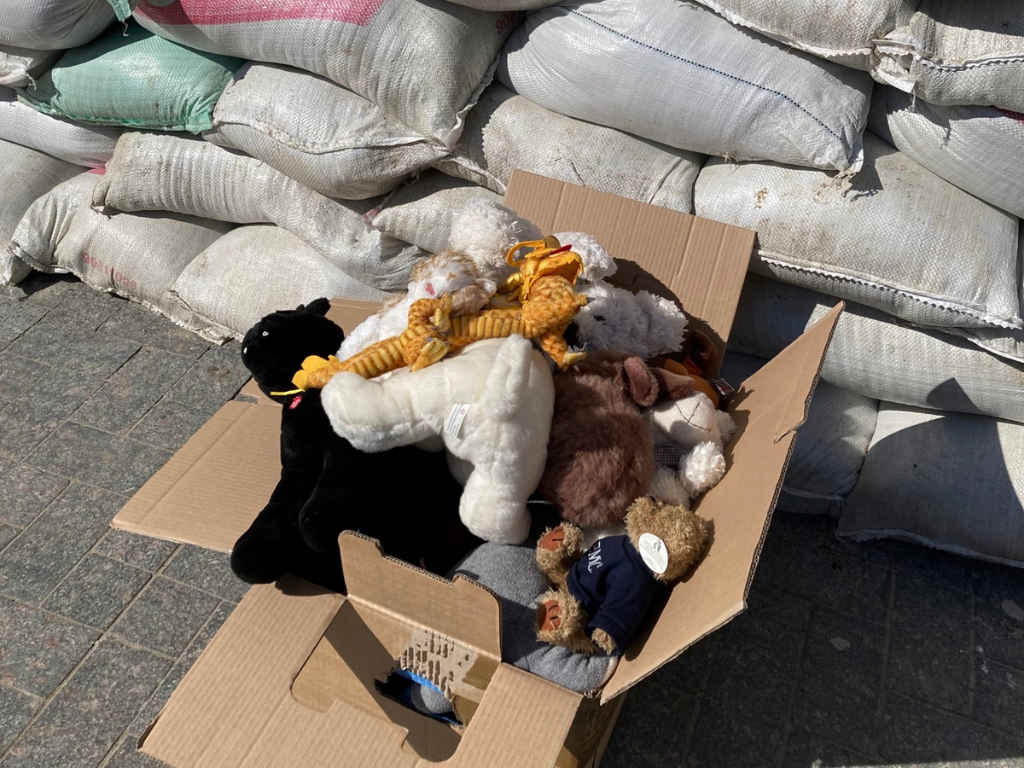 Picture of a box of toys near sand bags for children who've been forced to flee their homes in east Ukraine.