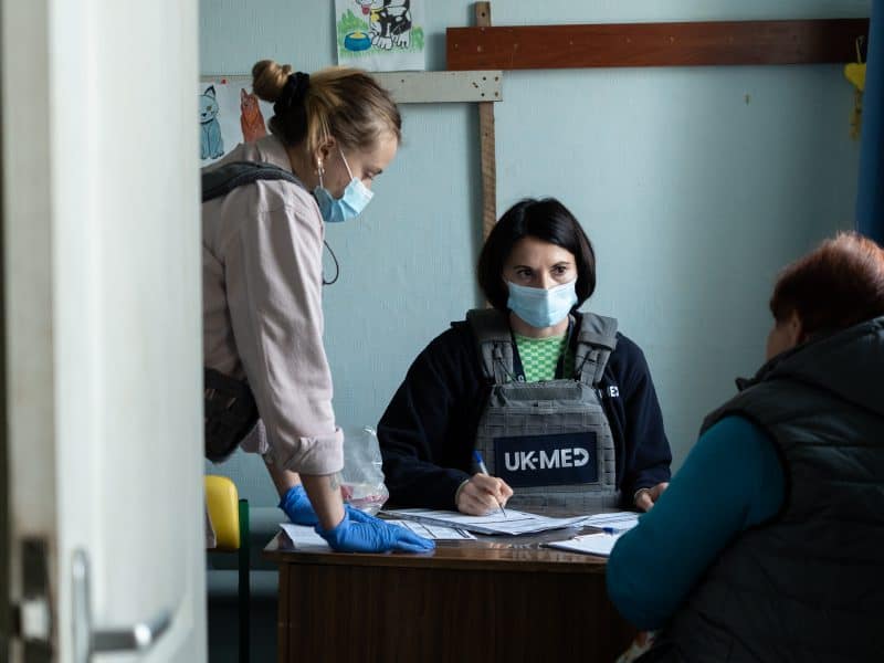 Dr Olena and Nurse Kateryna during a patient consultation in Hroza, a small village near the frontline. Despite the danger, UK-Med staff still visit these frontline communities to provide essential, lifesaving healthcare.